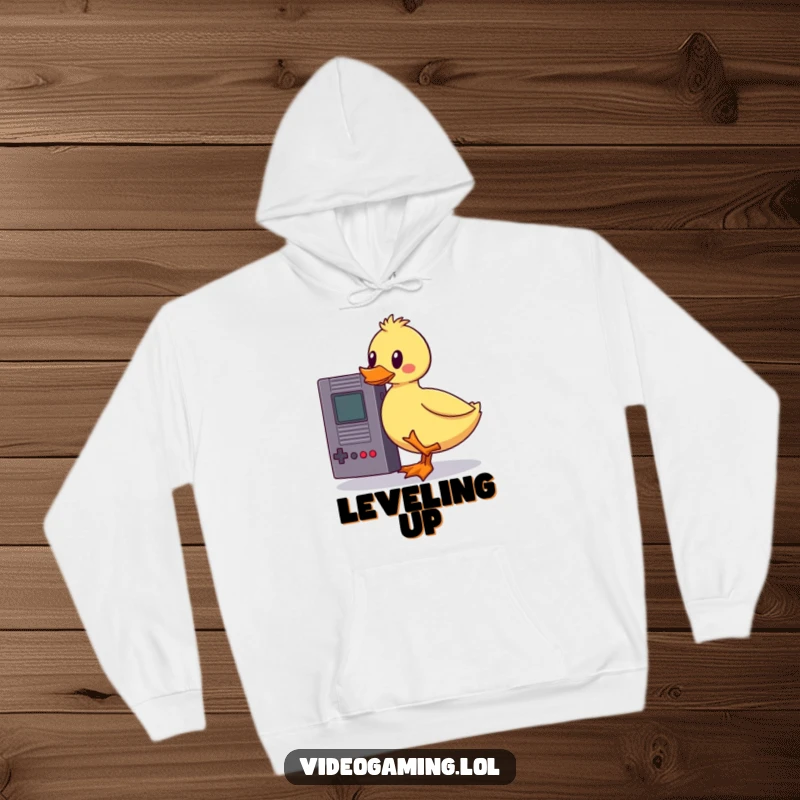 Funny wobbly duck hoodie, struggling to balance a vintage game cartridge, representing gamer dedication with a humorous twist, cozy and cool.